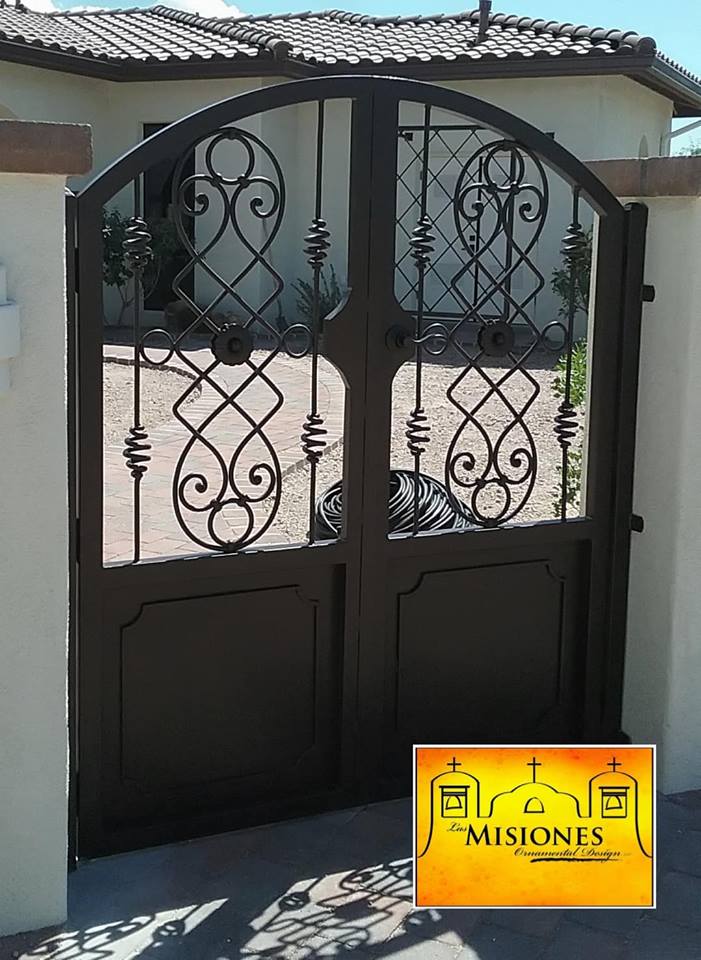 black narrow double door with twisty scrolls steel metal courtyard gate