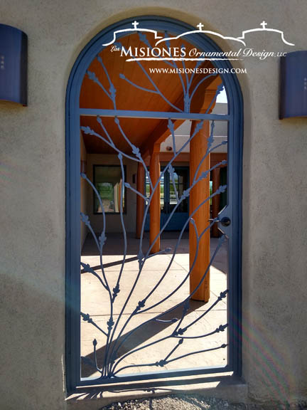 single door courtyard gate with simple vine-like patterning in black finish