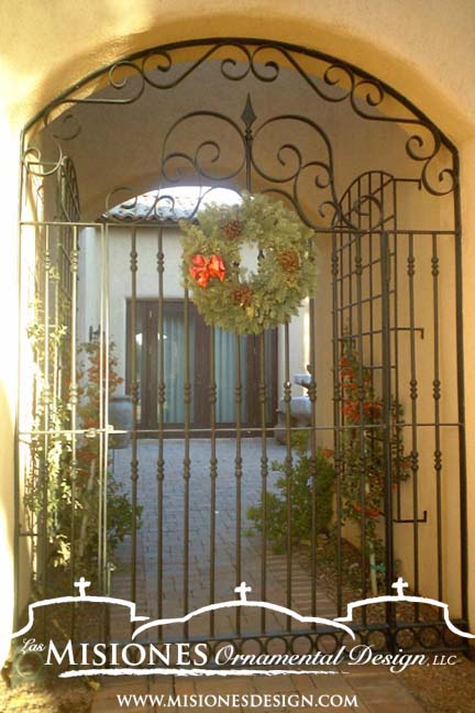 black tall arched steel metal courtyard gate