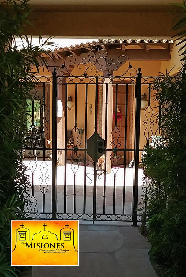 black steel metal courtyard gate, open to patio