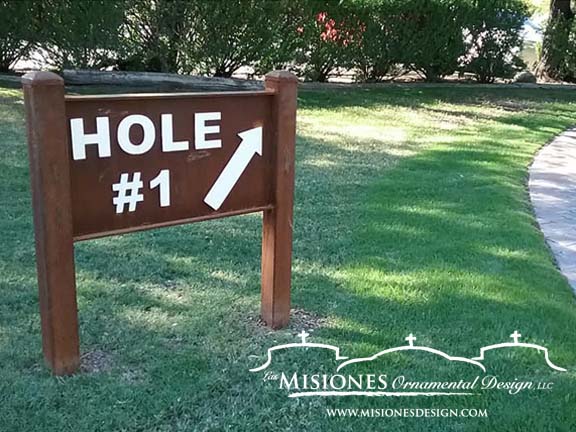 rust colored golf-course-sign, letters are raised and painted white