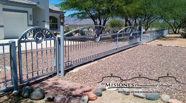 light blue, double driveway gate with an arch per side