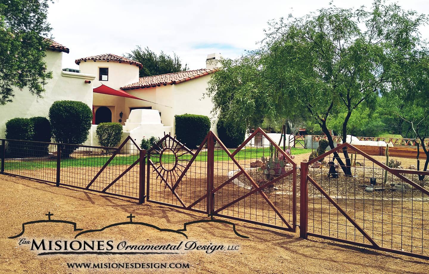 fencing with a large desert mountain landscape and sun at the entrance