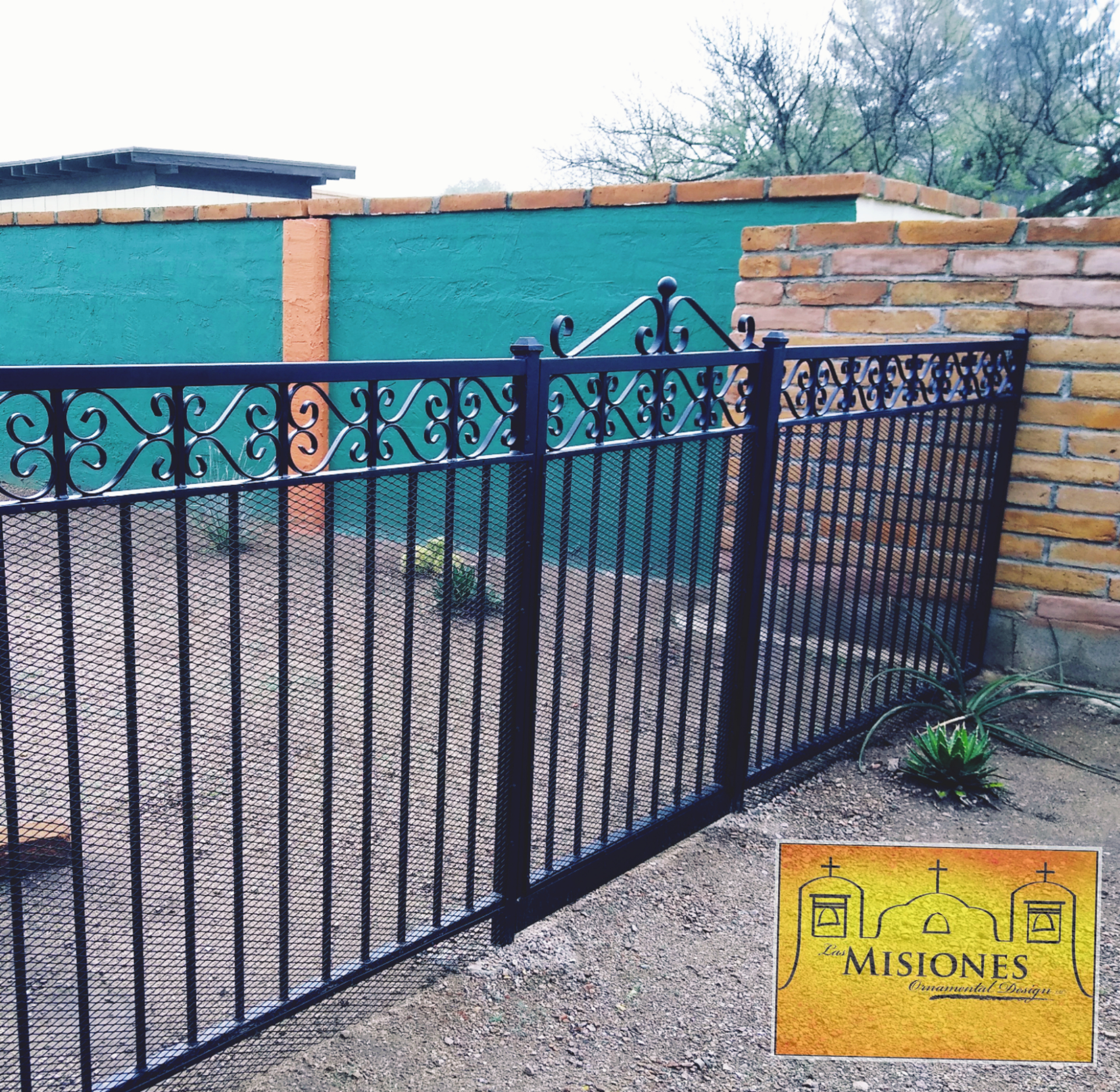 black fencing with simple vertical bars and scroll banding along the top