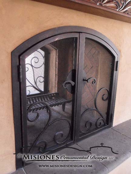 decorative brown fireplace screen with scrolls, double fireplace