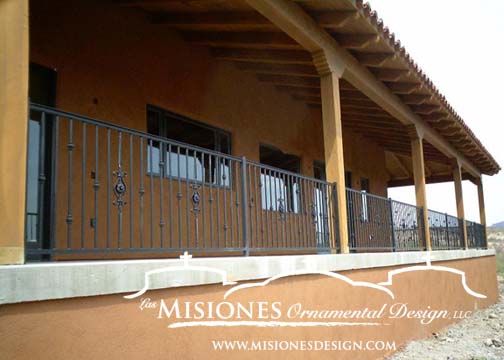 outdoor railing for raised wrap around porch, black vertical baluster paneling, some knuckle and ornamental steel design details