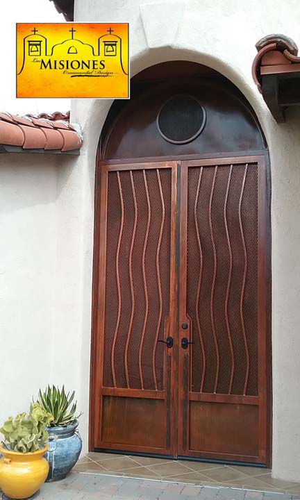 arched double door enclosure screen door with wavy line details in a rust finish