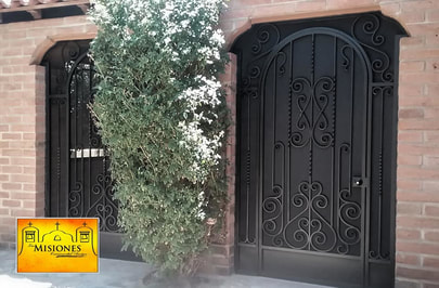 arched double door security screen door, black with kickplate, set into wall with surrounding steel paneling