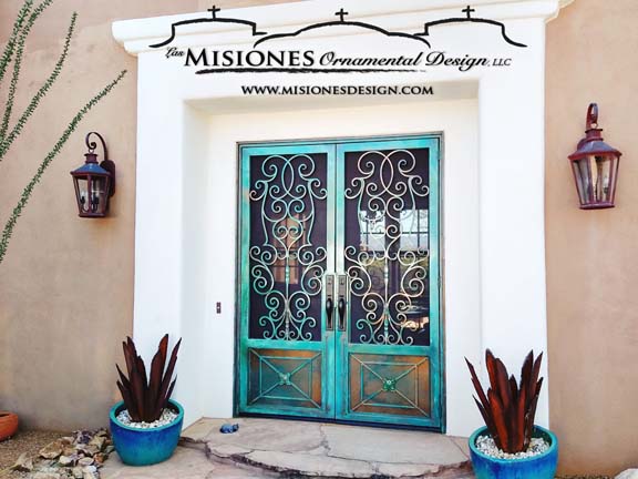 double security screen door with scrolls and decorative kickplates, in a turquoise patina