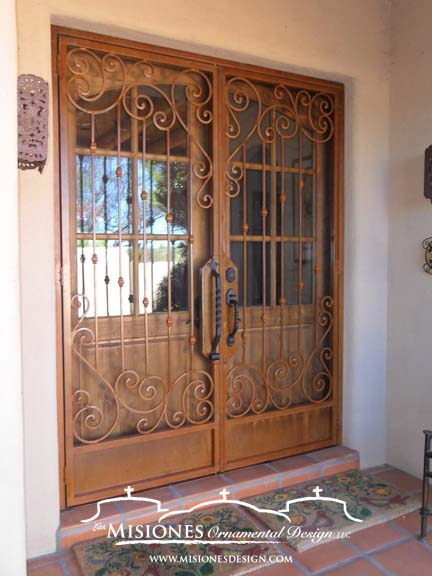 double security screen door in a romantic style of scrolls in a lacy effect with vertical bars with knuckle detailing, includes kickplates, in a rustic finish