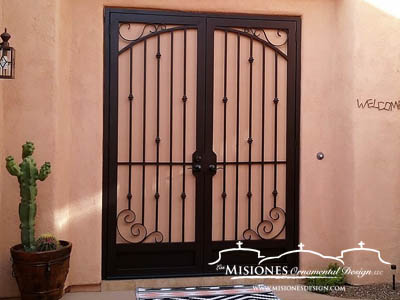 double security screen door with simple scroll touches in the corners but mainly vertical bars with knuckle detailing, in a black finish with kickplates