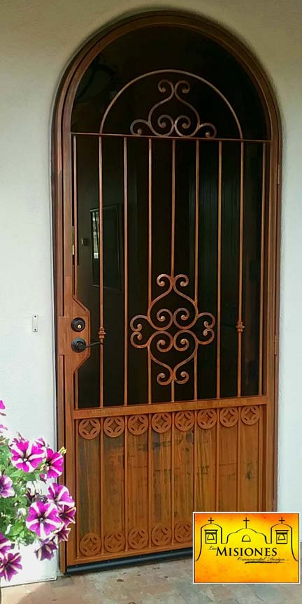 single arched security screen door with scrolls and vertical bars in a rust finish, included tall kickplate