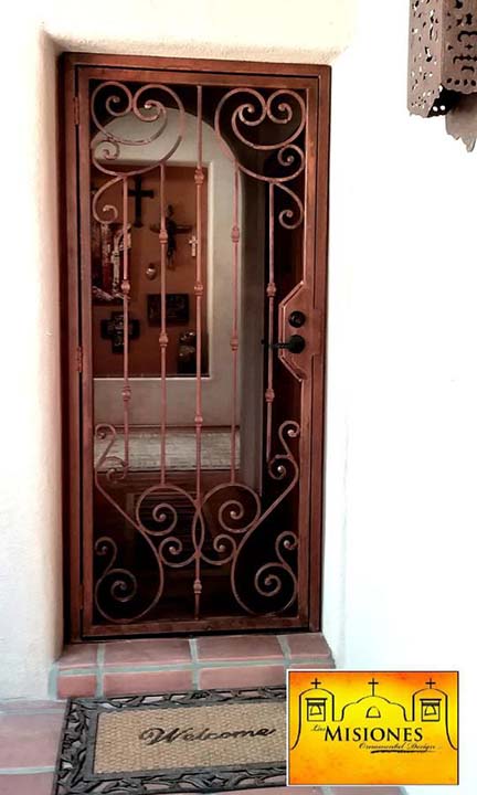 security screen door with gorgeous symmetrical scroll patterns framing the door in a rust finish